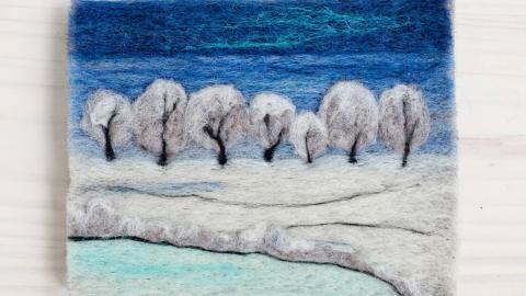 Needle-felted image of trees with a pond